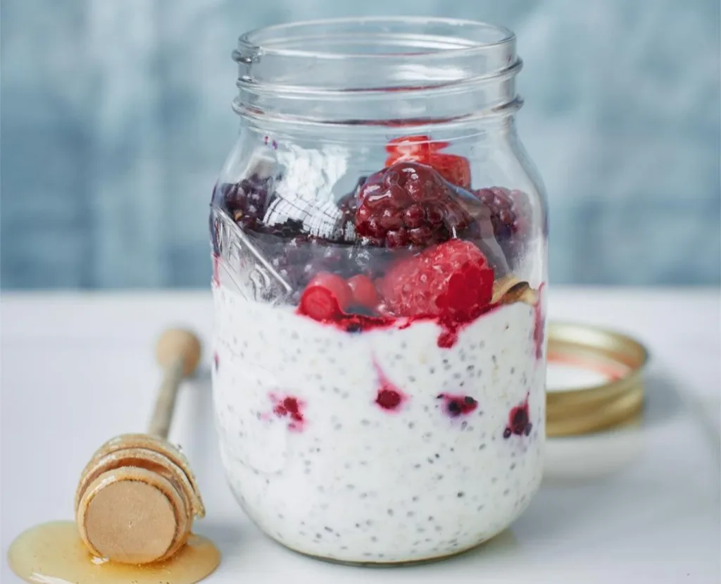 Jar of overnight oats with mixed fruits and chia seeds